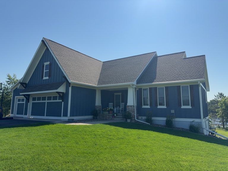 Navy blue farmhouse roof siding and gutters — Becker Roofing WI